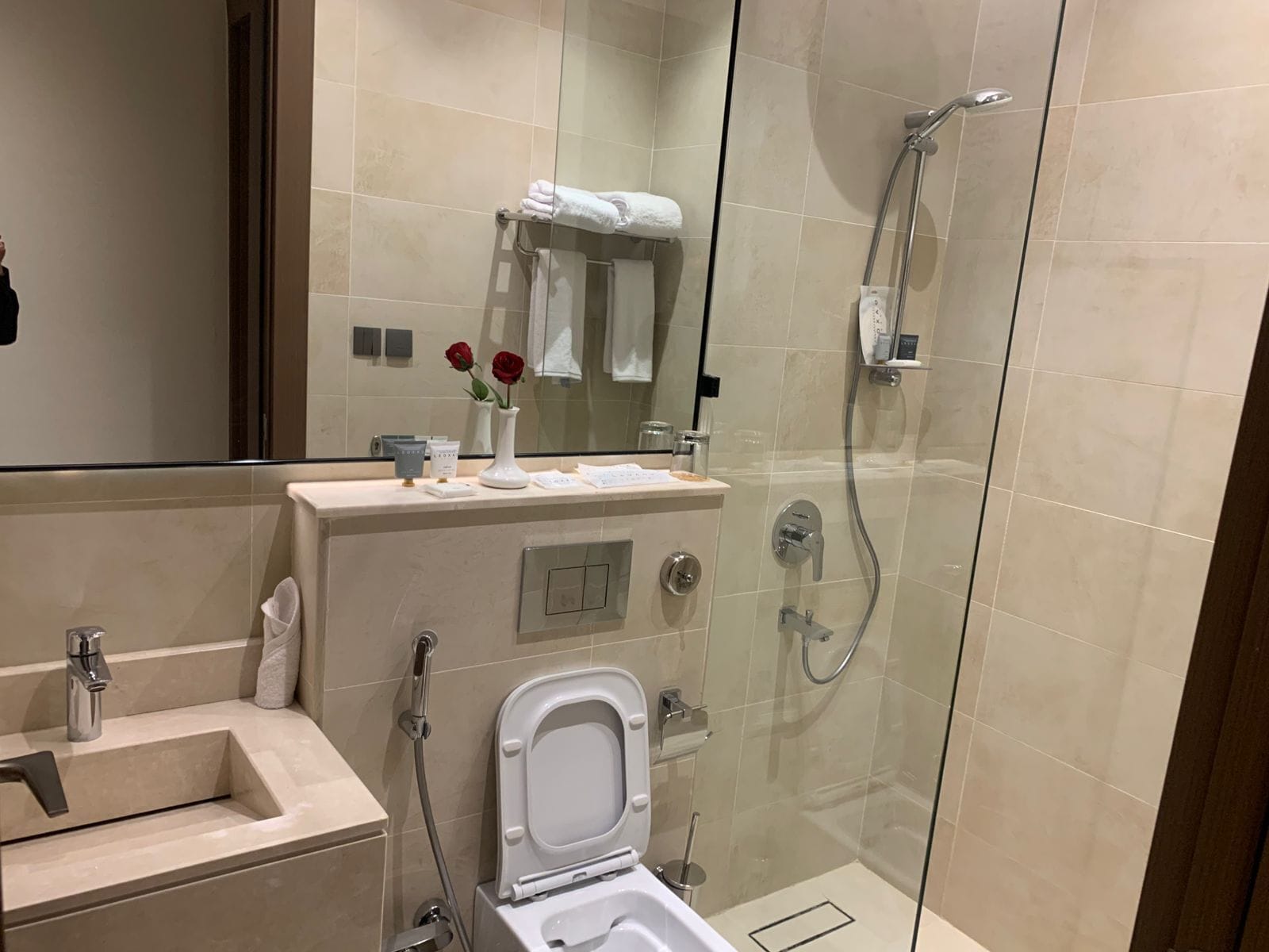 Shower, hair dryer, slippers, towels