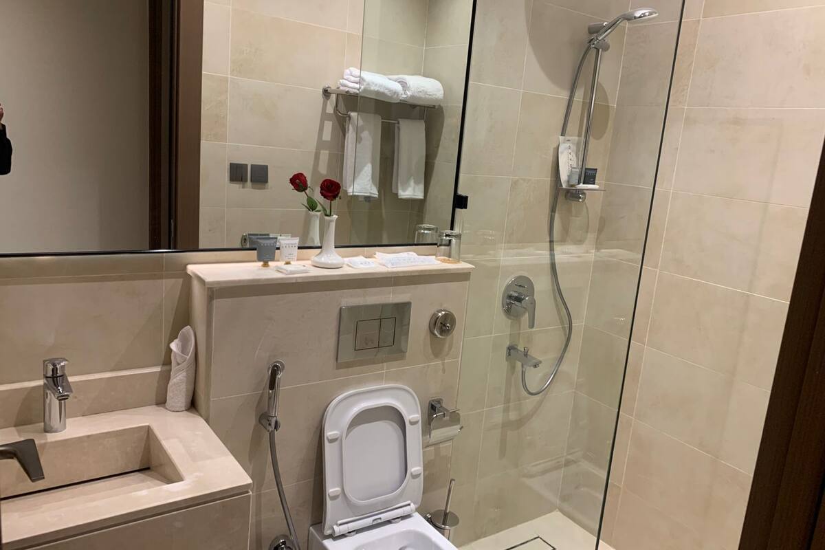 Shower, hair dryer, slippers, towels