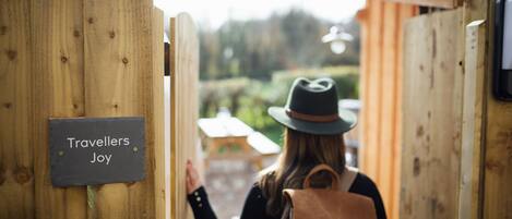 A wooden gate with a sign reading "Travellers Joy".
