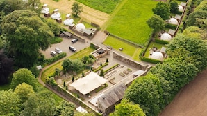 An aerial view of a rural property with several dome-shaped buildings, a parking area, and well-maintained gardens. - The Little Retreat (Kilgetty)