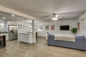 A modern kitchen with white cabinets, a stainless steel refrigerator, and pendant lighting. - 2 Mi to FSU! Group-Friendly Tallahassee Getaway (Tallahassee)