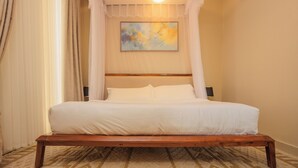 A neatly made bed with white linens, a wooden headboard, and a painting on the wall. - Amazing Pool View Apartment  perfect in Garuga-Entebbe with fitness room & WI-FI (Nkumba)