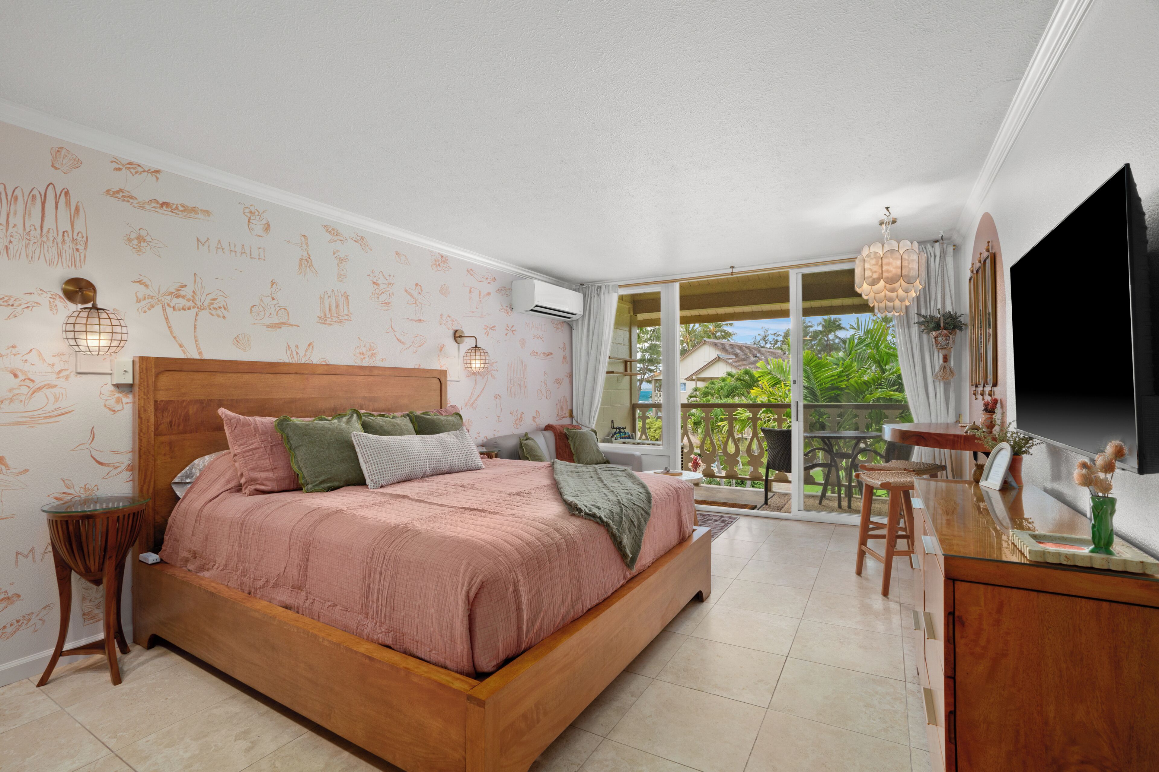 A bedroom with a wooden bed, a small table, and a TV.