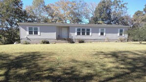 A single-story house with a front porch, a small front yard, and a garage. -  Beautiful piece of property in Westpoint. Great location for NATRA enthusiasts. (Westpoint)