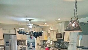 A modern kitchen with a central island, stainless steel appliances, and hanging pots. -  Beautiful piece of property in Westpoint. Great location for NATRA enthusiasts. (Westpoint)