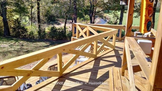 A wooden deck with a view of a natural landscape, including trees and a body of water. -  Beautiful piece of property in Westpoint. Great location for NATRA enthusiasts. (Westpoint)