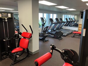 A gym with exercise equipment, treadmills, and a mirrored wall. - Long Beach Resort 4-1203 2-bedroom condo all new! Easy access & great views. (Panama City Beach)