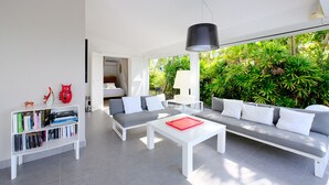 Un salon moderne avec un canapé, une table basse et une bibliothèque.