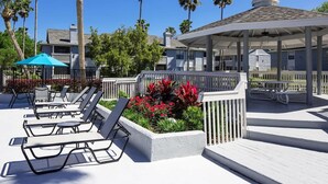 A poolside area with lounge chairs, a gazebo, and a covered seating area. - 1st Floor, Free PPV, Near Mayo Clinic, Pool, BBQ, (ponte vedra beach)