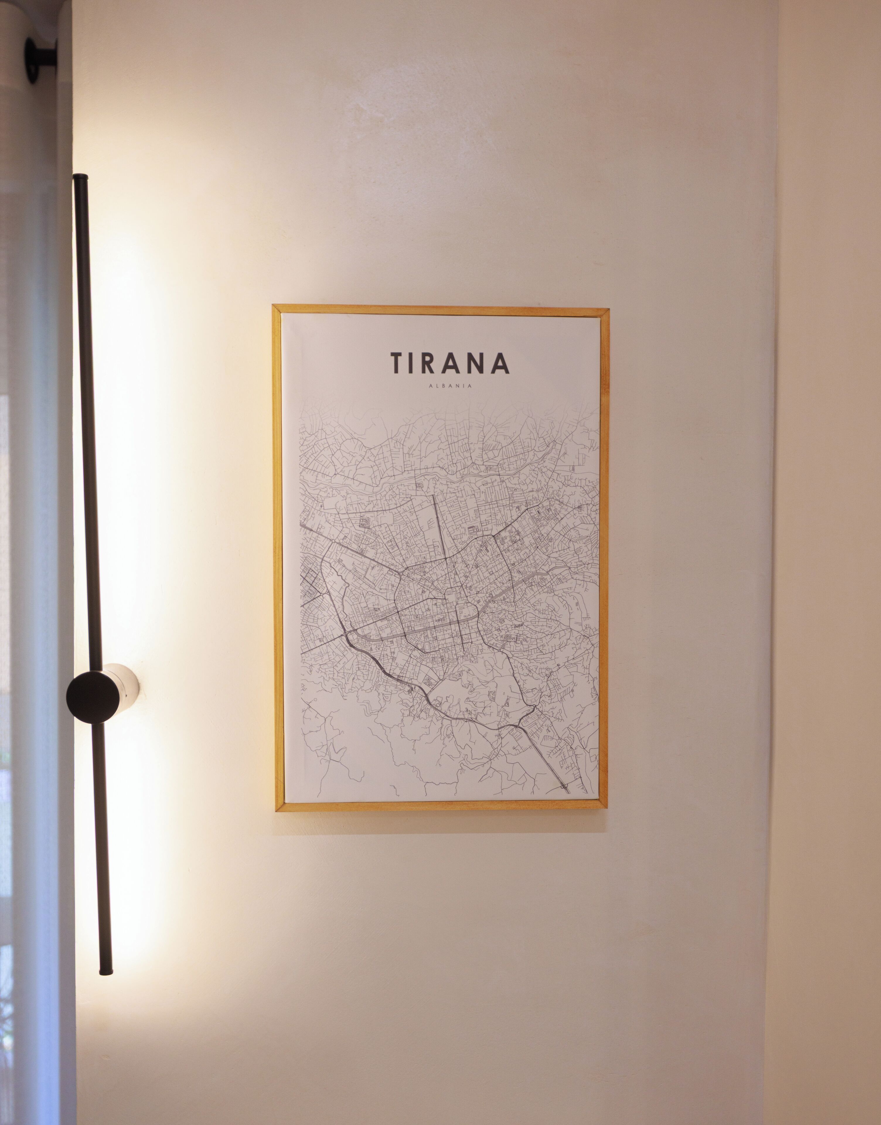 A framed map of Tirana, Albania, on a wall.