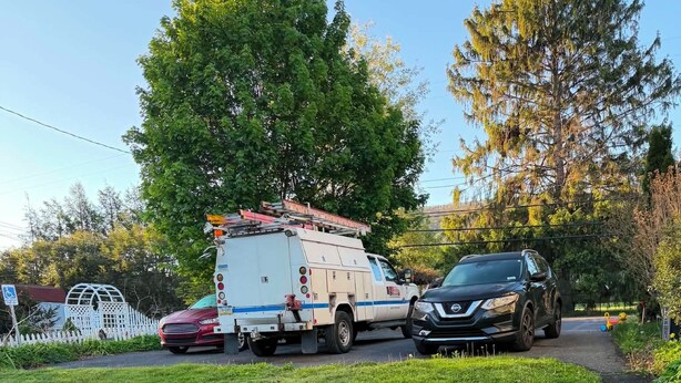 A grassy area with a paved path, a utility truck, and a parked car. - Cozy 1-bedroom apartment in tranquil Boalsburg 7 minutes from the stadium (Boalsburg)