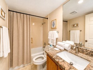 A bathroom with a bathtub, toilet, and sink. - Three Bedroom Two Bath Beachfront Condo (South Padre Island)