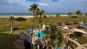 A resort with a pool, lounge chairs, and a beach view. - Three Bedroom Two Bath Beachfront Condo (South Padre Island)