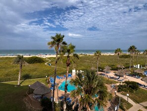 A resort with a pool, lounge chairs, and a beach view. - Three Bedroom Two Bath Beachfront Condo (South Padre Island)