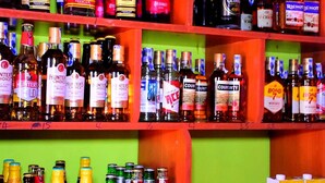 A bar shelf stocked with various bottles of alcohol, including brands like Hunter's Choice and County. - kuwetu resort and conference (Muthara)