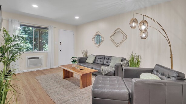 A modern living room with a sofa, a coffee table, and a floor lamp. - 2bed Apartment just 3 blocks from Downtown Martinez and Jobs (Martinez)