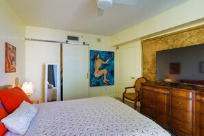 A bedroom with a bed, a dresser, a painting, a chair, and a television. - Suarez Art Stay, Scenic Miami View, Gym, Park (Miami)