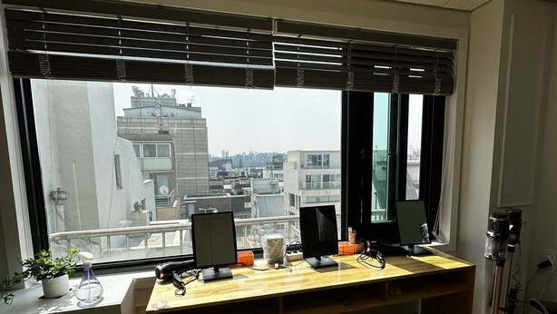 A modern office space with a large desk, two monitors, and a camera on a tripod. - K wave guesthouse only Female 2 (Seoul)