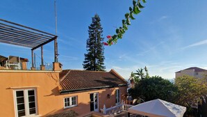 A swimming pool with a tiled deck, a building with a tiled roof, and a pergola. - Private driveway + pool + views of the straits (Gibraltar)