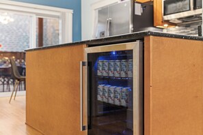 A compact kitchen with a built-in refrigerator and a microwave. - Spacious 3BR/2BA North Center Gem - 7-Min Walk to Brown Line - Fast Wi-Fi (Chicago)