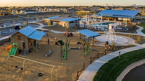 A playground with swings, slides, and climbing structures. - 3-bedroom Home in beautiful Queen Creek! (Queen Creek)