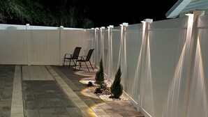 A patio with a white fence, stone tiles, and two small trees. - Perfect terrace to relax, have a coffee or enjoy the Florida weather. (Tampa)