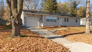 A single-story house with a garage, a front porch, and a driveway.