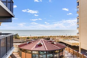 A high-rise building with a rooftop terrace overlooking a beach and ocean. - Sea Watch 318 (Ocean City)