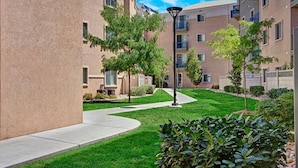 A residential building with multiple floors, balconies, and a well-maintained lawn. - 3-Bedroom Condo in the Heart of the City (Salt Lake City)