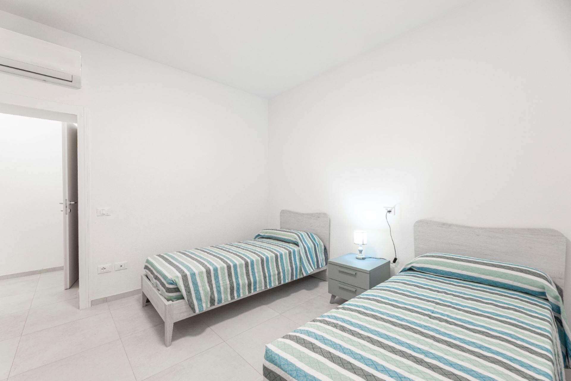 Een slaapkamer met twee bedden, een nachtkastje en een bedtafel.