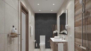 Ein modernes Badezimmer mit Toilette, Waschbecken und Dusche.