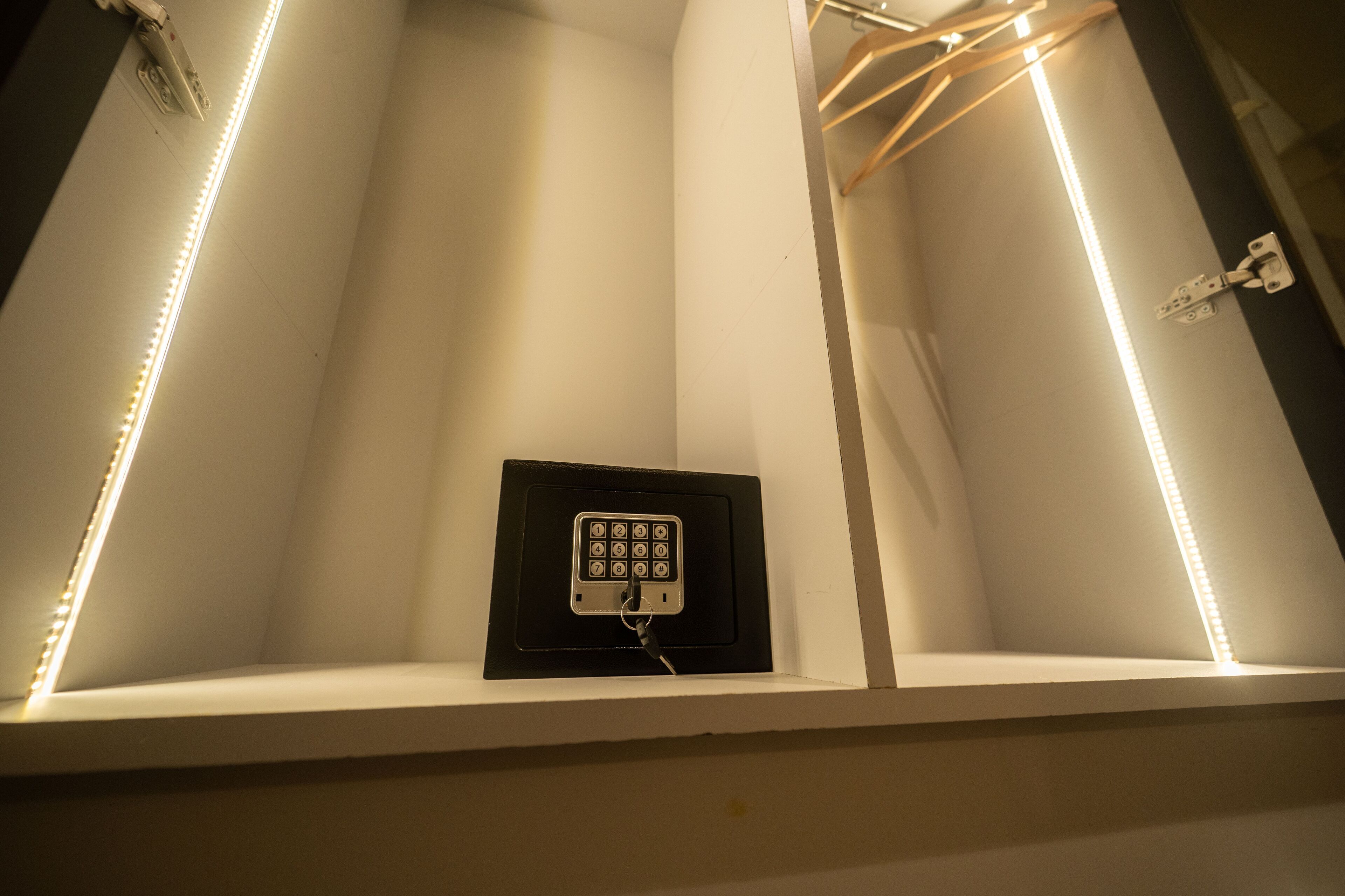 A bathroom with a built-in vanity, a mirror, and a light switch.