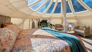 A tent with a bed, a chair, and a table. - Lakebrook Country Escape (Carlotta)