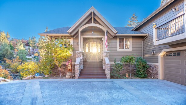 A two-story house with a stone foundation, a front porch, and a garage. - New! Bearadise ~ The Retreat (Big Bear Lake)