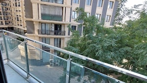 A high-rise residential building with multiple balconies and a glass railing. - Zarafshan city 64 Tashkent (Tashkent)