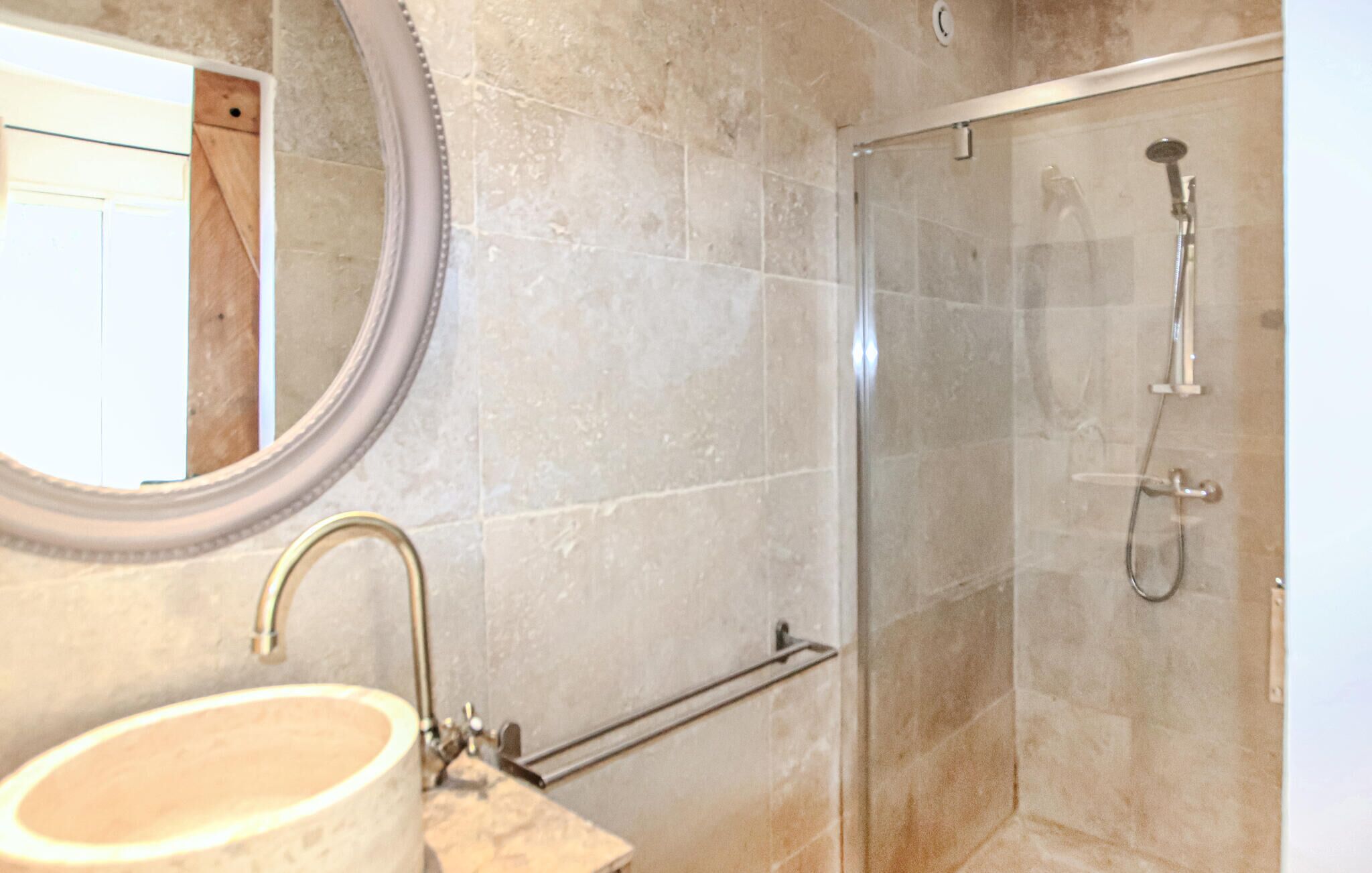 Ein Badezimmer mit Waschbecken, Spiegel und Dusche.