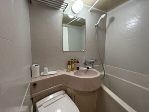 A bathroom with a toilet, sink, and shower. - PIOLAND HOTEL (Saitama)