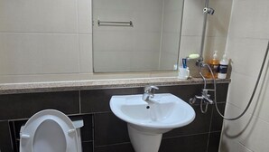 A bathroom with a toilet, sink, and shower. - Sky Motel (Gumi)