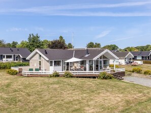 A row of mobile homes with a grassy lawn in front. - "Finn" - 100m from the sea by Interhome (Sydals)