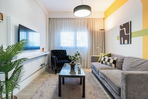 201 - 1BR City view | Living room | 43-inch Smart TV with digital channels, streaming services - Local Host Living - Signature Apartments in Nicosia (Nicosia)