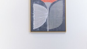 A framed artwork with abstract patterns, a round wooden table, and a matching chair. - Zenith Nishinakanobu (Tokyo)