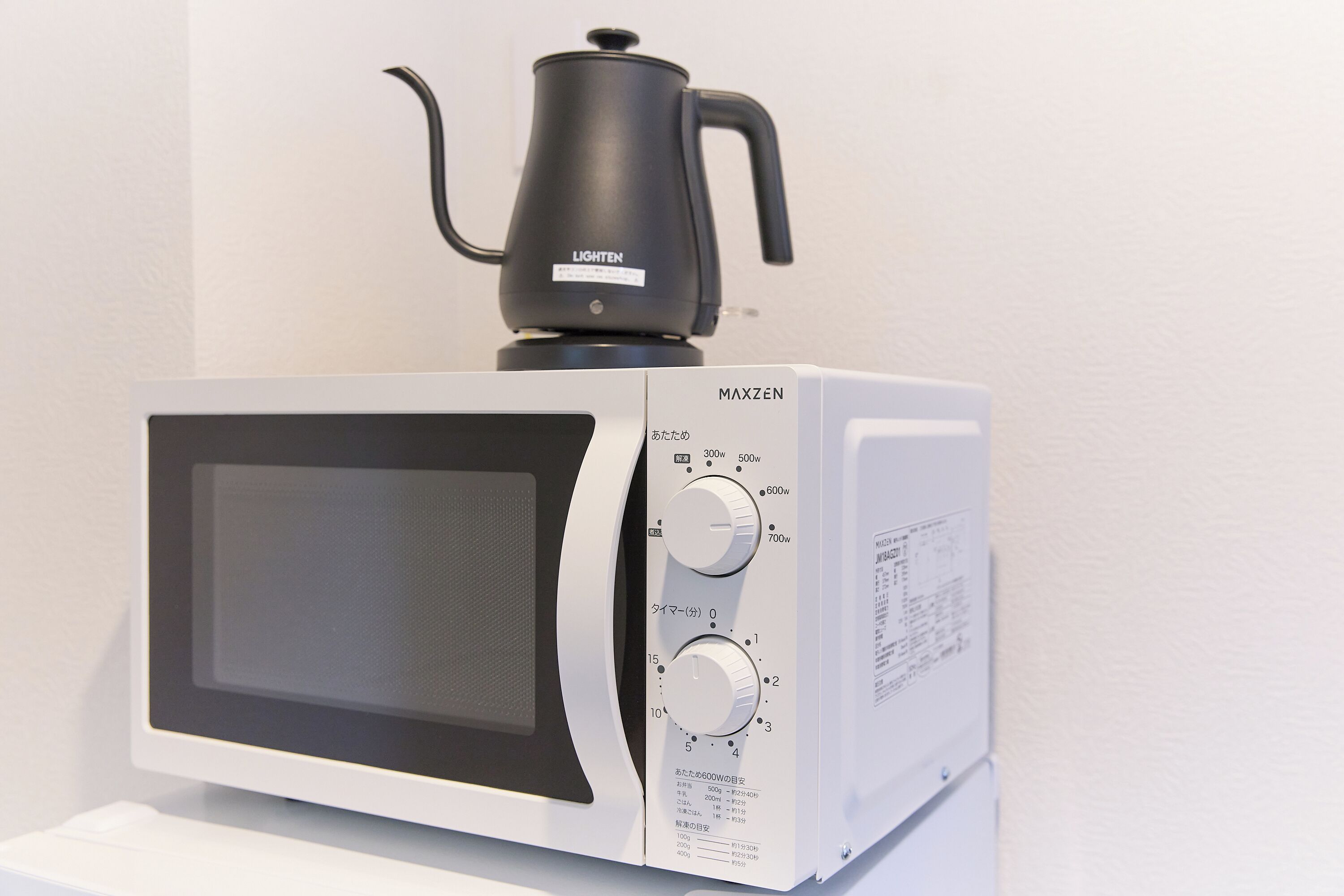 A microwave with a black pot on top, a digital display, and multiple control knobs.