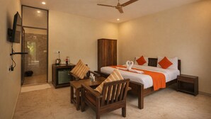 A hotel room with a bed, a desk, a chair, a wardrobe, and a shower area. - Rambagh Retreat-Stay with  Swimming Pool (Udaipur)