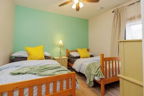 A room with two beds, a nightstand with a lamp, and a window with curtains. - Minutes to LakePoint Sports•3BR BSMT•Sleeps 10 (Acworth)