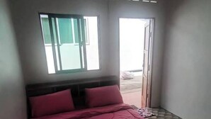 A bedroom with a bed, a window, and a door. - Double room fan outer bathroom 2 (Taphong)