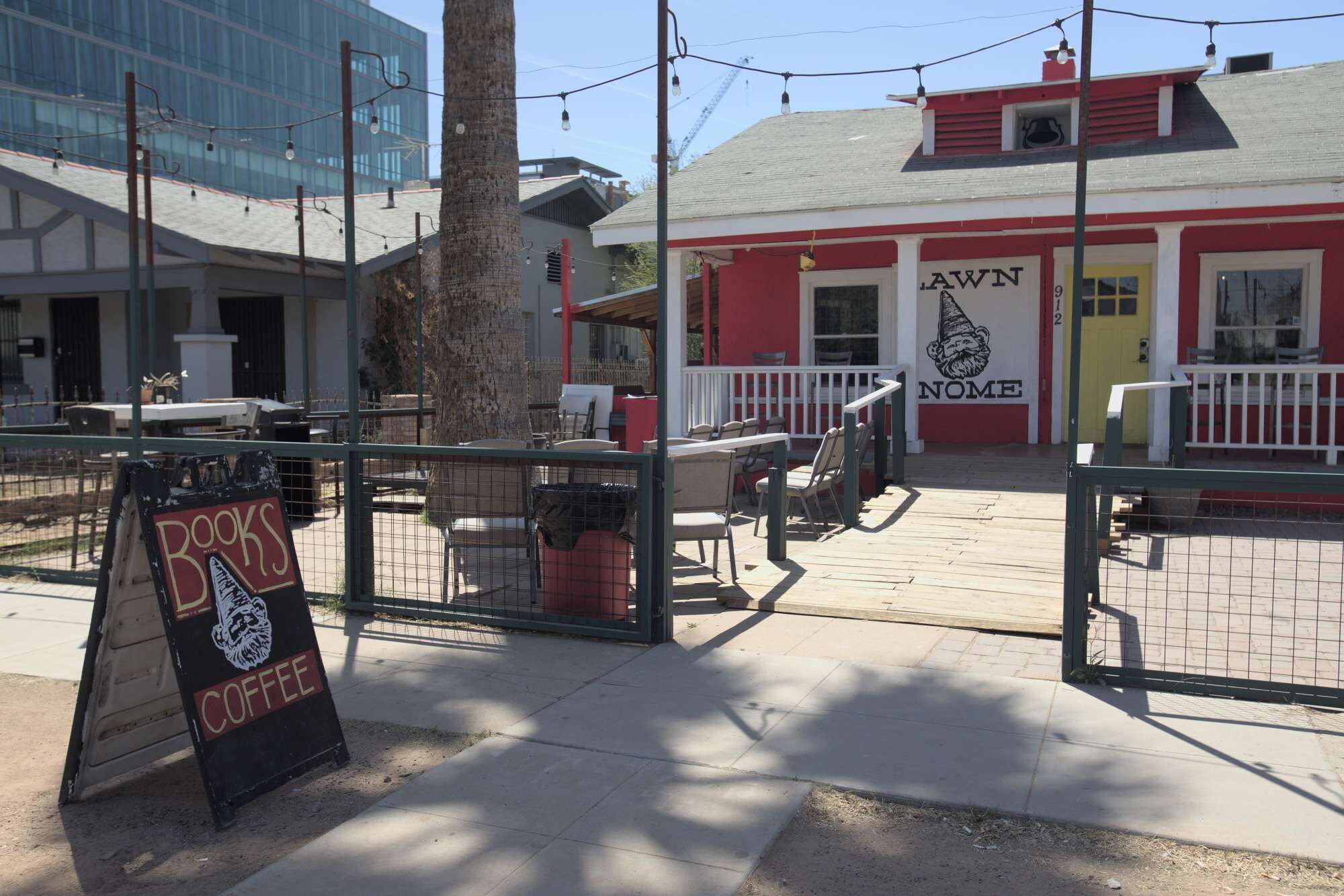 A red building with a sign reading "Lawn & Name" and outdoor seating.