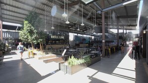 An indoor dining area with tables and chairs, a bar area, and hanging lights. - Compact Urban Living in DTPH – Pool (Phoenix)