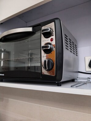 Luxury Studio Suite, City View | Private kitchen | Full-size fridge, microwave, oven, stovetop