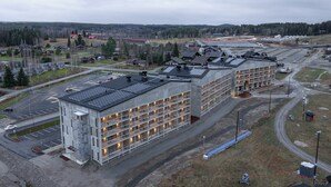 A large industrial building with multiple floors and a parking lot. - Break Sokos Hotel Himos (Jamsa)