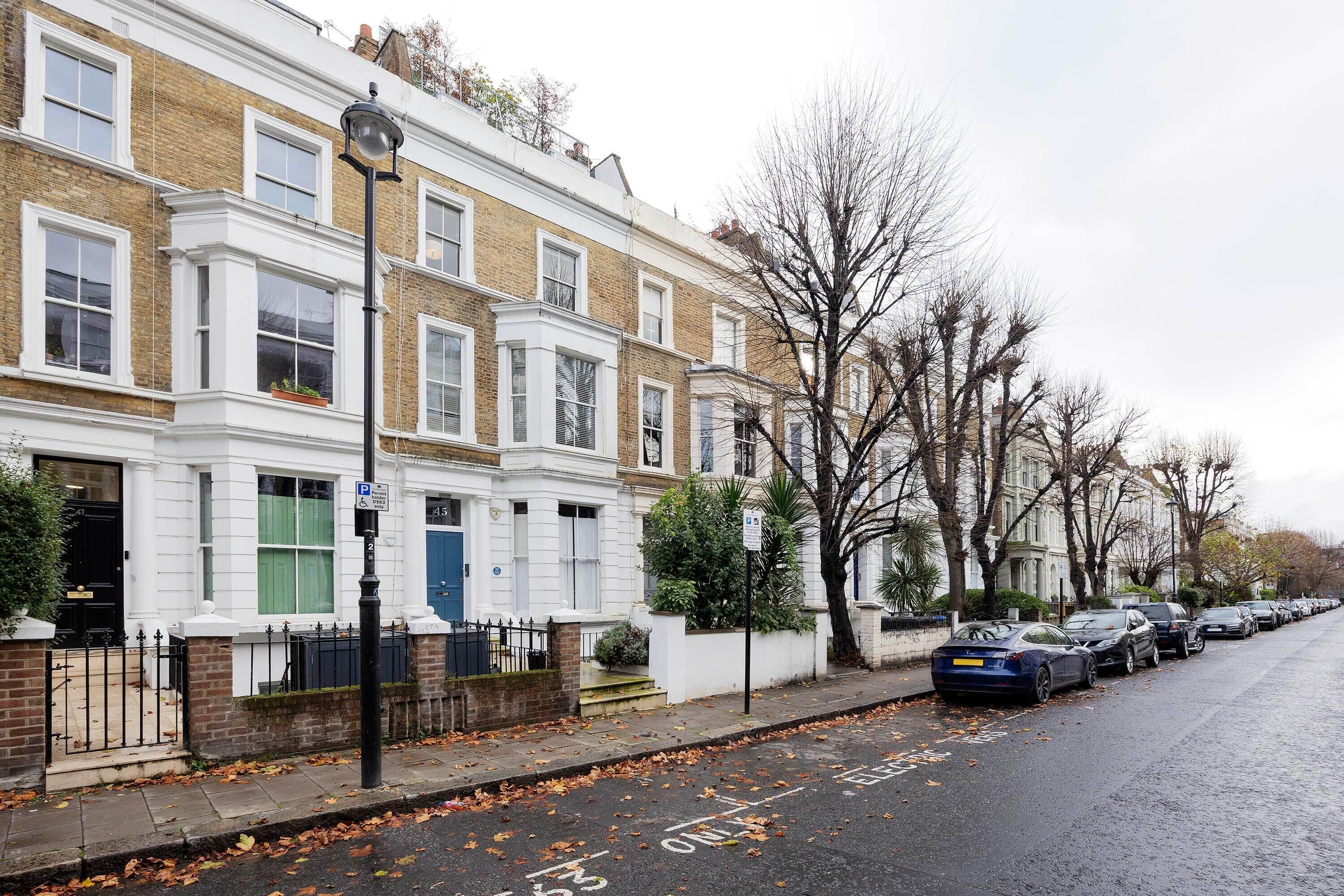 A row of terraced houses with a narrow street.